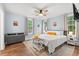 Serene main bedroom with light blue walls, hardwood floors, ceiling fan, and ample natural light at 412 29Th Ave. N, Myrtle Beach, SC 29577