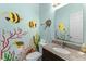 Fun bathroom featuring colorful ocean-themed wall art, granite countertop and decorative mirror at 6001 - N14 S Kings Hwy., Myrtle Beach, SC 29575