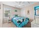 Charming bedroom featuring a rattan bed, white nightstand, and window with natural light at 6001 - N14 S Kings Hwy., Myrtle Beach, SC 29575
