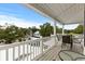 Outdoor deck area showcasing seating area and view of foliage and other homes at 6001 - N14 S Kings Hwy., Myrtle Beach, SC 29575