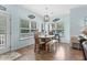 Light filled dining area with table, chairs, bench seating, and wood flooring at 6001 - N14 S Kings Hwy., Myrtle Beach, SC 29575