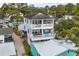 Charming two-story beach home features balconies, white railings, and glimpses of the surrounding neighborhood at 6001 - N14 S Kings Hwy., Myrtle Beach, SC 29575