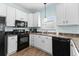 Well-equipped kitchen with white cabinets, black appliances, and laminate countertops at 6001 - N14 S Kings Hwy., Myrtle Beach, SC 29575