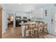 Bright kitchen featuring white cabinets, modern appliances, breakfast bar with seating, and wood floors at 6001 - N14 S Kings Hwy., Myrtle Beach, SC 29575