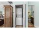 Convenient laundry closet with stacked washer and dryer, adjacent to a wooden storage cabinet at 6001 - N14 S Kings Hwy., Myrtle Beach, SC 29575