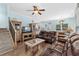 Spacious living room area with hardwood floors, leather sofas, and an open view to the kitchen and dining area at 6001 - N14 S Kings Hwy., Myrtle Beach, SC 29575
