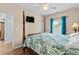 Spacious main bedroom featuring a four-poster bed, ceiling fan, and natural light at 6001 - N14 S Kings Hwy., Myrtle Beach, SC 29575