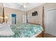 Main bedroom featuring a four-poster bed, ceiling fan, TV, and ensuite bathroom at 6001 - N14 S Kings Hwy., Myrtle Beach, SC 29575