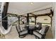 Covered patio with seating, a hammock, and a grill, perfect for relaxing and entertaining outdoors at 6001 - N14 S Kings Hwy., Myrtle Beach, SC 29575