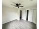 Spacious bedroom featuring a ceiling fan, vinyl floors, and ample closet space for organized living at 6306 Somerset Dr., Myrtle Beach, SC 29572