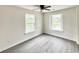 Well-lit bedroom with vinyl flooring, two windows, and neutral walls, providing a relaxing and adaptable space at 6306 Somerset Dr., Myrtle Beach, SC 29572
