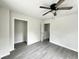 Spacious bedroom with modern ceiling fan, neutral walls, and durable vinyl flooring for easy maintenance at 6306 Somerset Dr., Myrtle Beach, SC 29572