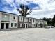 Townhomes with light green and white exterior paint, sidewalks, and a spacious parking lot at 6306 Somerset Dr., Myrtle Beach, SC 29572