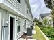 View of the rear of townhomes featuring light green paint, and well-maintained landscaping at 6306 Somerset Dr., Myrtle Beach, SC 29572