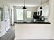 Charming kitchen featuring modern appliances, a breakfast bar, and ample natural light from the window at 6306 Somerset Dr., Myrtle Beach, SC 29572