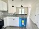 Modern kitchen with granite countertops, stainless steel sink, new dishwasher, and access to the stairs at 6306 Somerset Dr., Myrtle Beach, SC 29572