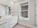 Bright bathroom with a double sink vanity, large mirror, and window for natural light at 512 9Th Ave. S, North Myrtle Beach, SC 29582