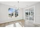 Bright dining room with large windows, sliding glass doors, and modern chandelier at 512 9Th Ave. S, North Myrtle Beach, SC 29582