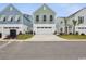 Charming exterior view of townhomes with vibrant colors and modern architectural details at 512 9Th Ave. S, North Myrtle Beach, SC 29582