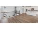Bright interior featuring hardwood floors and staircase with stylish railing, leading to a modern kitchen at 512 9Th Ave. S, North Myrtle Beach, SC 29582
