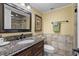 Bathroom with granite countertop and large vanity mirror at 517 S Ocean Blvd. # 605, North Myrtle Beach, SC 29582