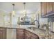 Kitchen features granite countertops, stainless steel sink, and dark wood cabinets at 517 S Ocean Blvd. # 605, North Myrtle Beach, SC 29582