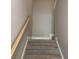 Carpeted staircase with wooden handrail, providing safe access to the upper level at 3125 Tiger Tail Rd., Conway, SC 29526