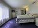 Bedroom featuring a large bed with a blue and white comforter, a window, and carpeted floors at 4290 Pinehurst Circle # B6, Little River, SC 29566