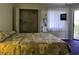 Well-lit bedroom featuring a comfortable bed, closet space, and exterior access at 4290 Pinehurst Circle # B6, Little River, SC 29566