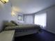Bedroom featuring a large bed with a blue and white comforter and a bright window at 4290 Pinehurst Circle # B6, Little River, SC 29566