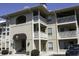 Multi-level condo building with well-kept exteriors, balconies, and visible entry awning at 4290 Pinehurst Circle # B6, Little River, SC 29566