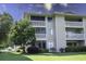 Exterior of a multi-story condo building featuring screened porches and well-maintained landscaping at 4290 Pinehurst Circle # B6, Little River, SC 29566