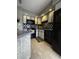 Cozy kitchen with white and black cabinets, tile backsplash, and modern appliances at 4290 Pinehurst Circle # B6, Little River, SC 29566