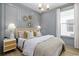 Stylish bedroom featuring a statement wall, hardwood floors, and a large window providing tons of natural light at 512 9Th Ave. S, North Myrtle Beach, SC 29582