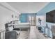 Bedroom with light blue accent wall, herringbone floors, and access to a private balcony at 1207 S Ocean Blvd. # 20604, Myrtle Beach, SC 29577