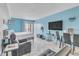 Bedroom with light blue accent wall, herringbone floors, and access to a private balcony at 1207 S Ocean Blvd. # 20604, Myrtle Beach, SC 29577