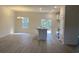 Open-concept living and dining area featuring hardwood floors, sliding doors, and neutral paint at 1581 Highway 701 South, Loris, SC 29569
