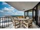 This balcony features a dining table set with seating, complemented by ocean and city views at 9650 Shore Dr. # 1805, Myrtle Beach, SC 29572