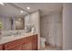 Well-lit bathroom with a granite countertop, cherry wood cabinets, and neutral tile flooring at 9650 Shore Dr. # 1805, Myrtle Beach, SC 29572