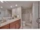 Elegant bathroom featuring cherry wood cabinets, granite counters, a large mirror, and a walk-in shower at 9650 Shore Dr. # 1805, Myrtle Beach, SC 29572