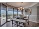 Bright dining area with large windows, modern light fixture, and seating for six, offering scenic views at 9650 Shore Dr. # 1805, Myrtle Beach, SC 29572