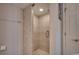 Tiled stand-up shower with glass door, built-in shower caddy, and neutral color palette at 9650 Shore Dr. # 1805, Myrtle Beach, SC 29572