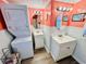 Bright bathroom with two vanities, decorative mirrors, and a stacked washer and dryer at 6001 - N21 S Kings Hwy., Myrtle Beach, SC 29575