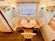 Cozy dining area with wood table, seating for three and cute beach themed decor at 6001 - N21 S Kings Hwy., Myrtle Beach, SC 29575