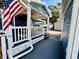 Home exterior showcasing covered patio with outdoor seating and the property's convenient golf cart, plus U.S. flag at 6001 - N21 S Kings Hwy., Myrtle Beach, SC 29575