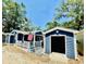 Charming blue home with a garage, covered patio, and an American flag displayed on the porch at 6001 - N21 S Kings Hwy., Myrtle Beach, SC 29575