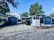 Charming blue home with white trim, features a covered patio, spacious driveway, and a convenient golf cart at 6001 - N21 S Kings Hwy., Myrtle Beach, SC 29575