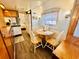 Charming kitchen and dining area boasts of an intimate dining arrangement next to a window at 6001 - N21 S Kings Hwy., Myrtle Beach, SC 29575