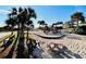 Community playground in sand featuring slides, swings and jungle gym with nearby benches and picnic table at 6001 - N21 S Kings Hwy., Myrtle Beach, SC 29575