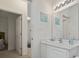 Bright bathroom featuring a vanity with sink and a mirror, toilet, and doorway leading to the bedroom at 2090 Cross Gate Blvd. # 205, Surfside Beach, SC 29575